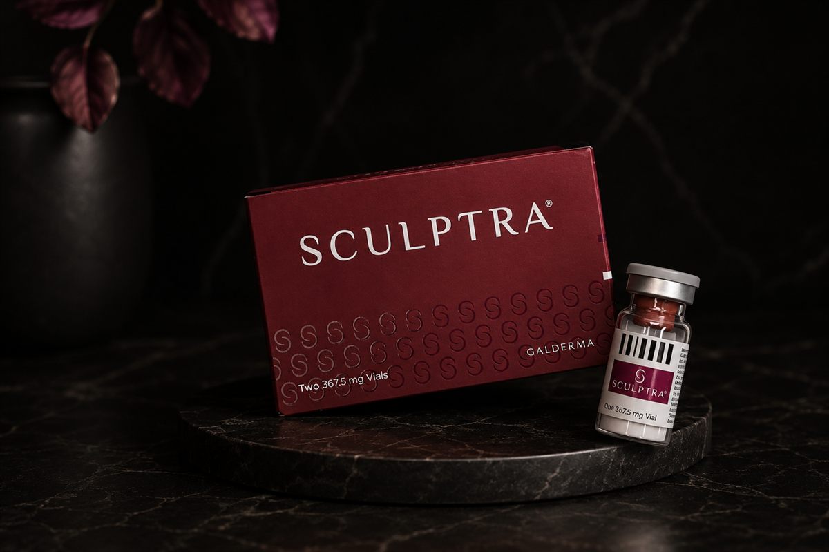 Sculptra box and vial centered on a dark luxury surface for collagen support treatment planning at Calibrae Institute of Aesthetic Medicine